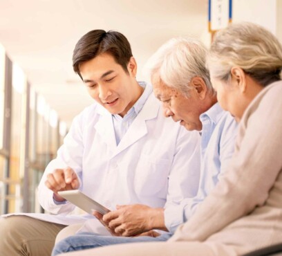 Asian senior couple in wheelchair consulting an asian male doctor