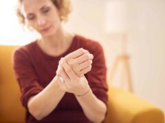 Caucasian female patient holding her clenched fist