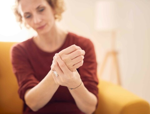 Caucasian female patient holding her clenched fist