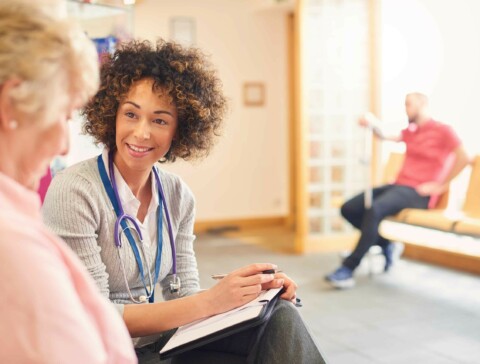 Caucasian senior female patient consulting a middle age african female doctor