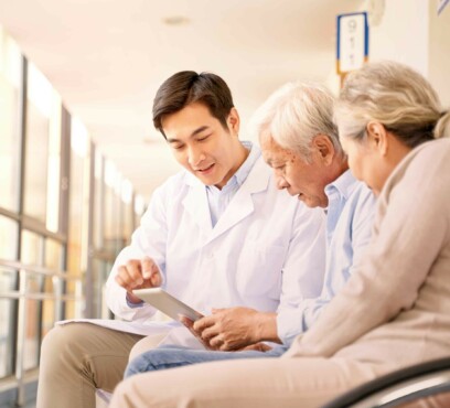 Asian senior couple in wheelchair consulting an asian male doctor