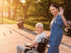 Senior caucasian male patient in a wheelchair with a female nurse